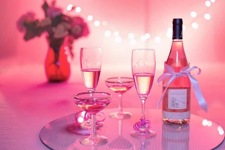 Table with champagne, glasses and flowers