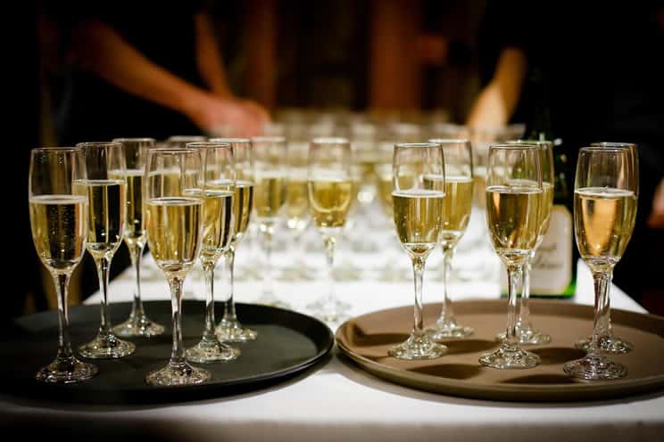 Table lined up with glasses of champagne