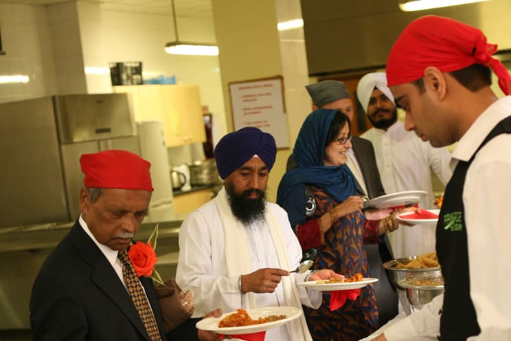 Sikh in langar hall for Milni eating. 