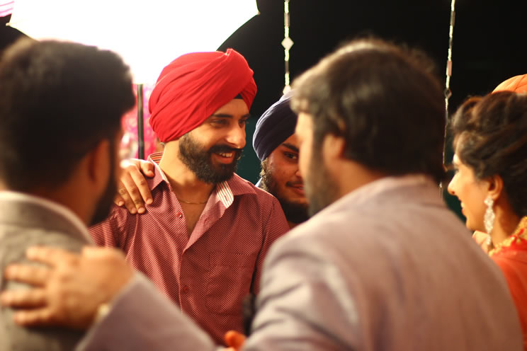 Sikh men chatting at a wedding
